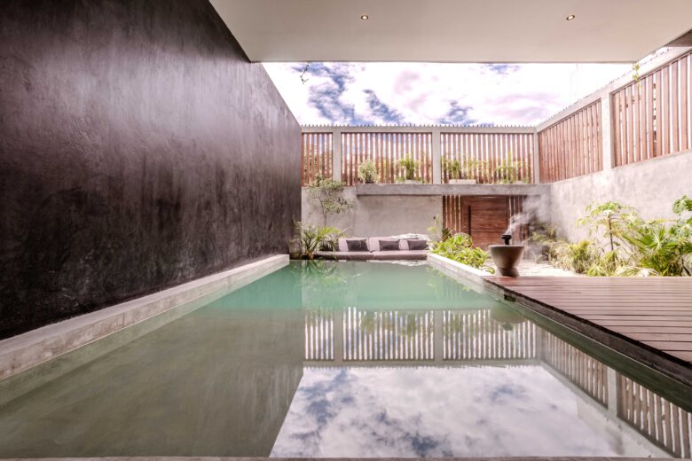 Private pool at ANANA Casa Karmond luxury villa in Tulum, with modern design and lush tropical garden.