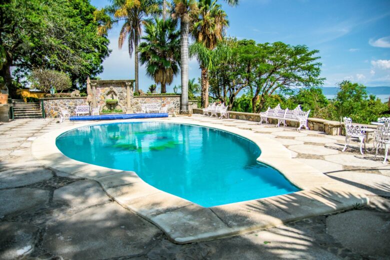 Private pool with lounge chairs and lake in the background at Rancho San Rafael